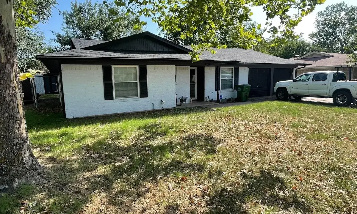 Professional roofing crew working on a residential roof in Savoy